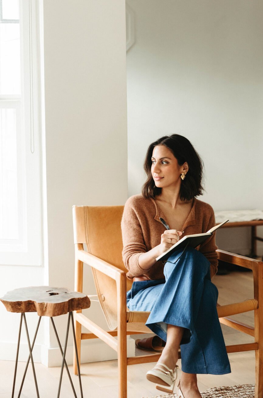 Woman journaling in self-care guide.